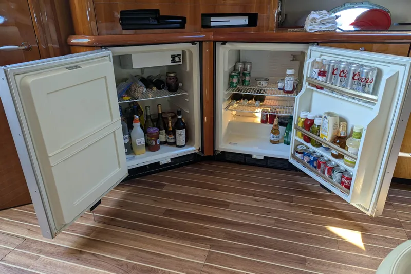 Yacht Photos Pics Open fridge on 2006 Sunseeker Predator 68 yacht, stocked with beverages and condiments.
