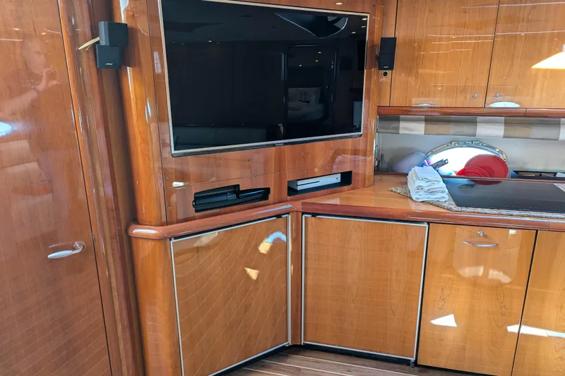  Yacht Photos Pics Luxurious interior of 2006 Sunseeker Predator 68 yacht with wood cabinetry and entertainment system.