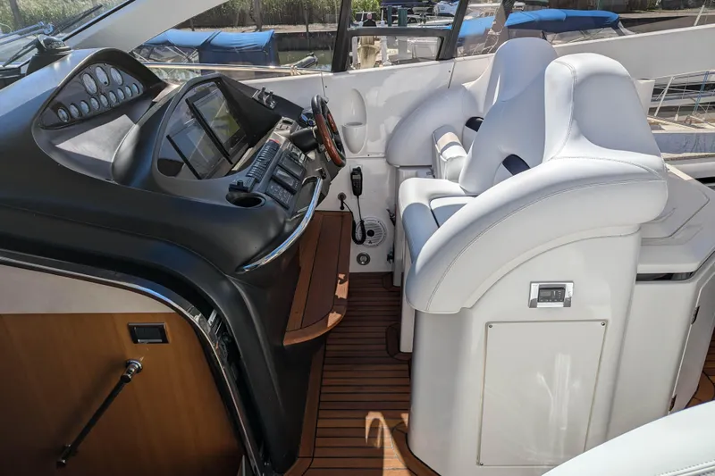  Yacht Photos Pics Luxurious helm of 2006 Sunseeker Predator 68 yacht with modern controls and seating.