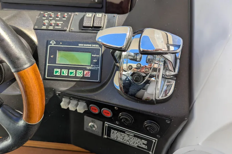  Yacht Photos Pics Control panel of a 2006 Sunseeker Predator 68 yacht with steering wheel and throttle levers.