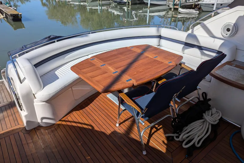 Yacht Photos Pics Luxury Sunseeker Predator 68 yacht deck with seating and wooden table, 2006 model.