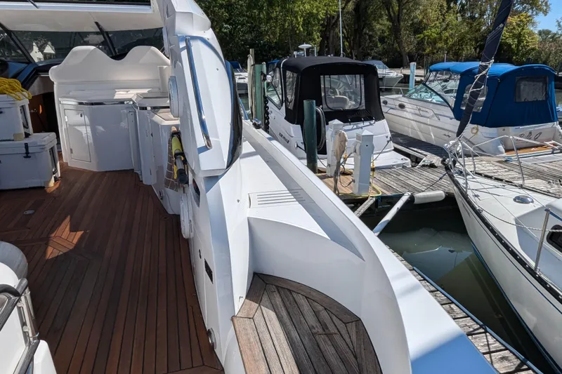  Yacht Photos Pics 2006 Sunseeker Predator 68 yacht docked, featuring sleek design and wooden deck.