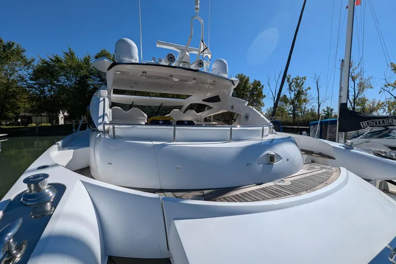  Yacht Photos Pics 2006 Sunseeker Predator 68 yacht, sleek design, docked in a serene marina setting.