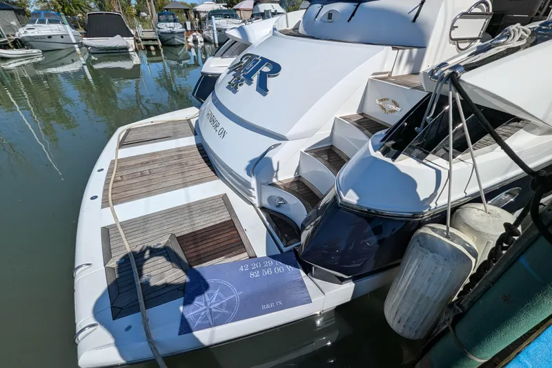  Yacht Photos Pics 2006 Sunseeker Predator 68 yacht docked, featuring sleek design and wooden deck details.