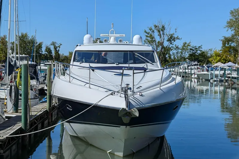  Yacht Photos Pics 2006 Sunseeker Predator 68 yacht docked in a serene marina setting.
