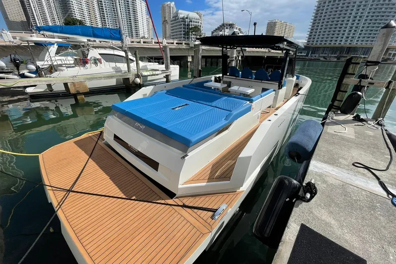  Yacht Photos Pics 2021 De Antonio Yachts Center Console docked, featuring sleek design and modern amenities.