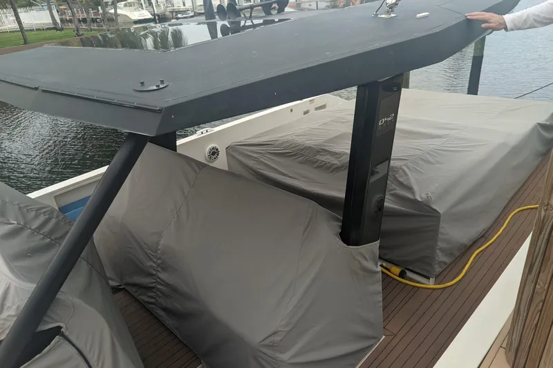  Yacht Photos Pics 2021 De Antonio Yachts Center Console with covered deck, docked by the water.