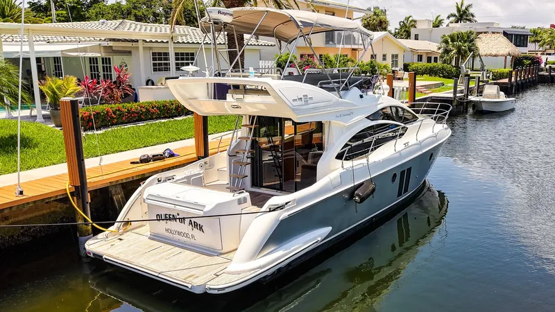 Queen Of Ark Yacht Photos Pics 2017 Azimut 42 Fly yacht docked in a sunny canal setting.