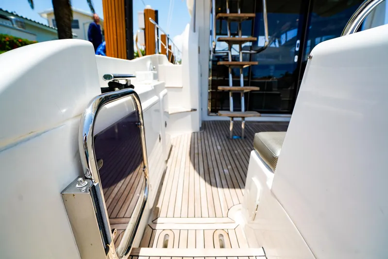 Queen Of Ark Yacht Photos Pics Azimut 42 Fly 2017 yacht deck with wooden flooring and metal railings.