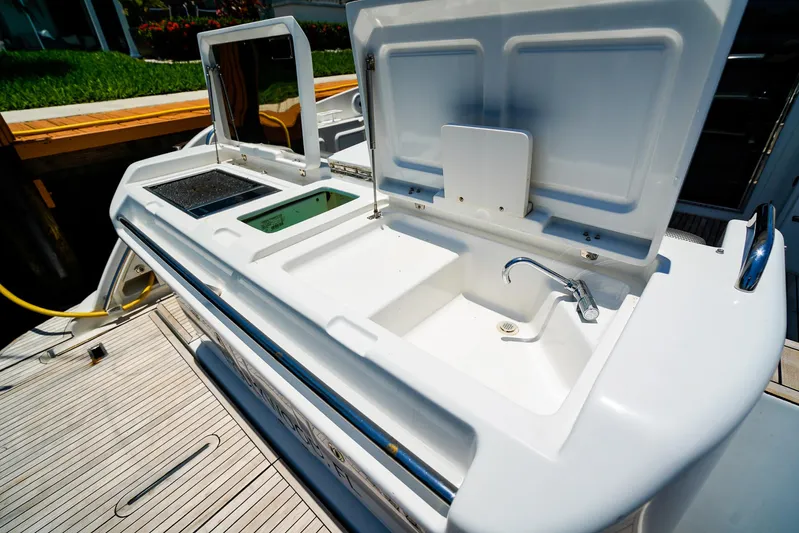 Queen Of Ark Yacht Photos Pics Outdoor kitchen area on a 2017 Azimut 42 Fly yacht, featuring a sink and grill.