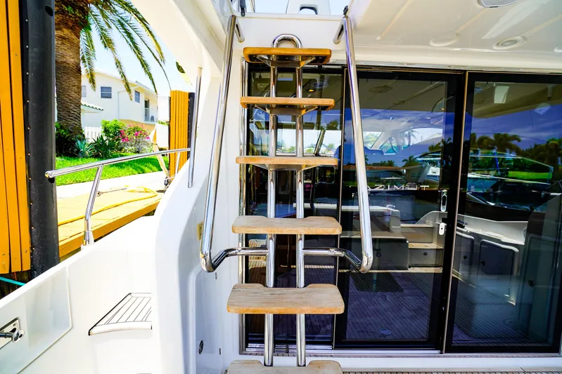Queen Of Ark Yacht Photos Pics Staircase on 2017 Azimut 42 Fly yacht, leading to upper deck with glass doors.