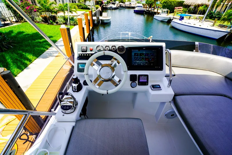 Queen Of Ark Yacht Photos Pics Cockpit of 2017 Azimut 42 Fly yacht with modern controls and waterfront view.