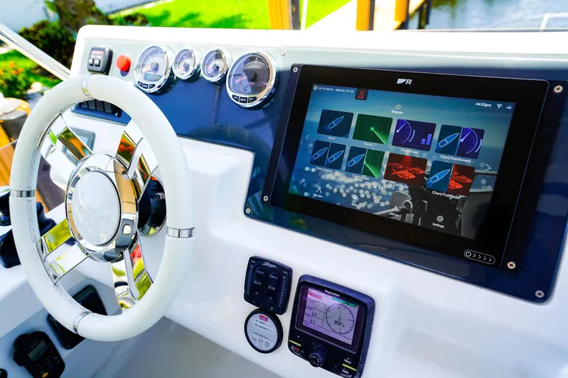 Queen Of Ark Yacht Photos Pics Control panel of 2017 Azimut 42 Fly yacht with touchscreen and steering wheel.
