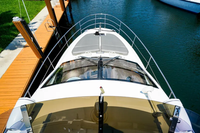 Queen Of Ark Yacht Photos Pics 2017 Azimut 42 Fly yacht docked in a serene marina setting.