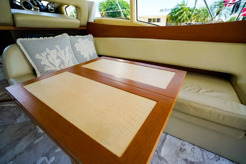 Queen Of Ark Yacht Photos Pics Luxurious interior of 2017 Azimut 42 Fly yacht with elegant seating and wooden table.