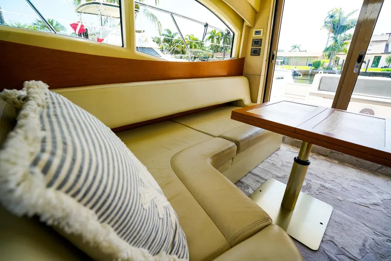 Queen Of Ark Yacht Photos Pics Luxurious interior of 2017 Azimut 42 Fly yacht with plush seating and elegant table.