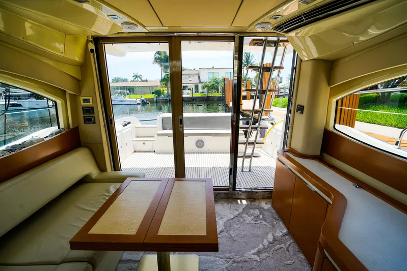 Queen Of Ark Yacht Photos Pics Interior view of 2017 Azimut 42 Fly yacht with elegant seating and outdoor access.