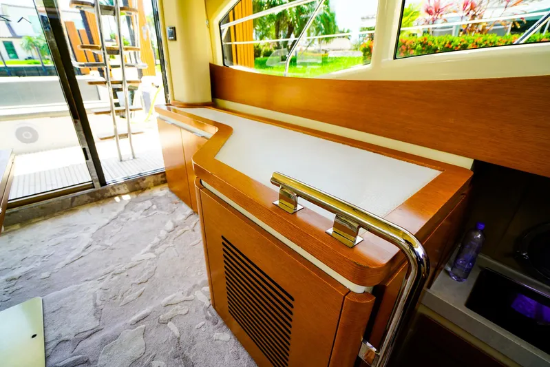 Queen Of Ark Yacht Photos Pics Interior of 2017 Azimut 42 Fly yacht with modern wood cabinetry and large windows.