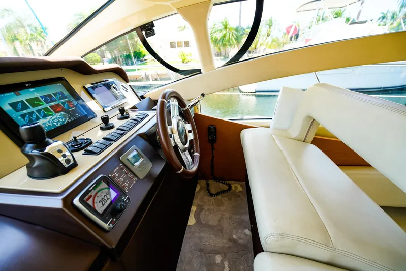 Queen Of Ark Yacht Photos Pics Interior cockpit of 2017 Azimut 42 Fly yacht with modern navigation controls.