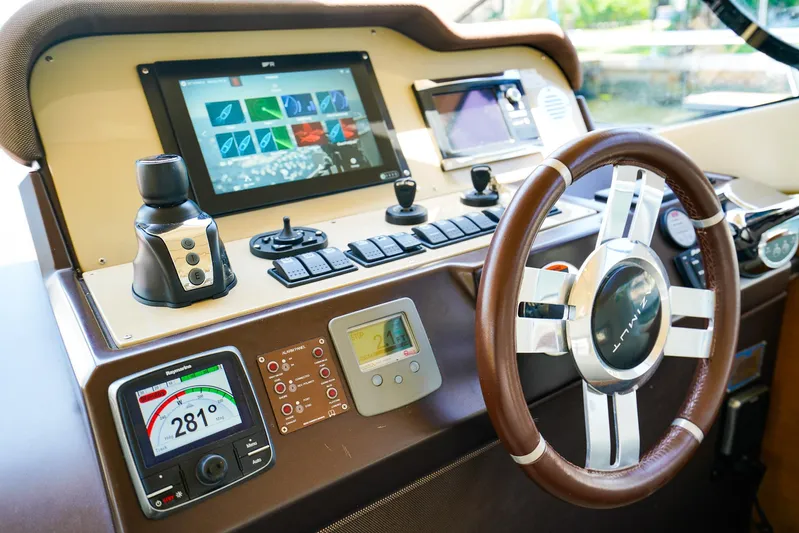 Queen Of Ark Yacht Photos Pics Cockpit of 2017 Azimut 42 Fly yacht with advanced navigation controls and steering wheel.