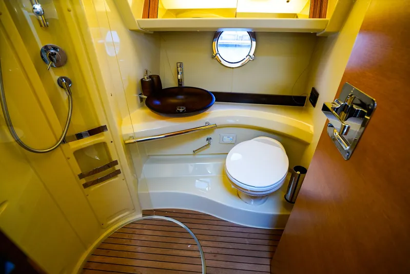 Queen Of Ark Yacht Photos Pics Luxurious bathroom in 2017 Azimut 42 Fly yacht with modern fixtures and wooden flooring.