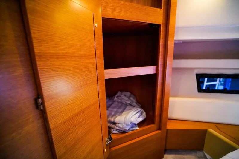 Queen Of Ark Yacht Photos Pics Wooden cabinet interior on 2017 Azimut 42 Fly yacht with folded linens.