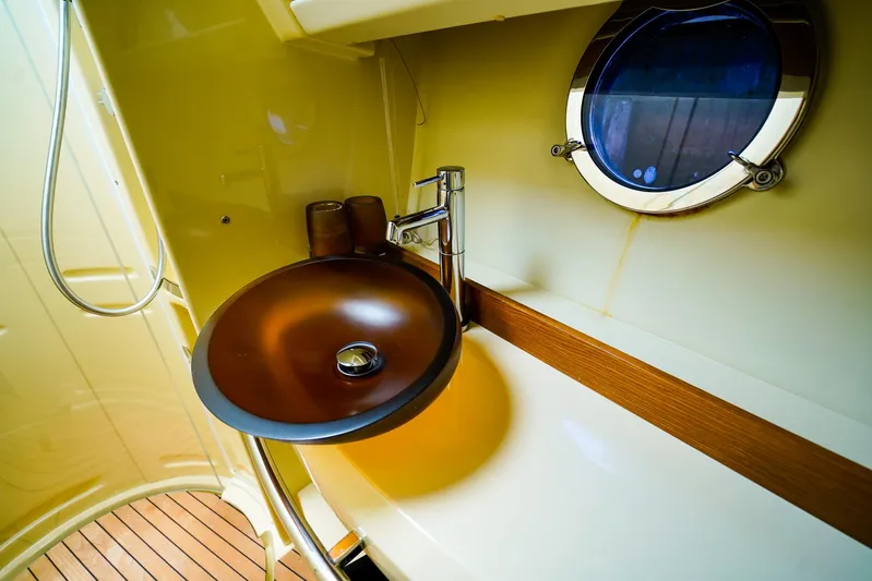 Queen Of Ark Yacht Photos Pics Luxurious bathroom sink on 2017 Azimut 42 Fly yacht with porthole view.