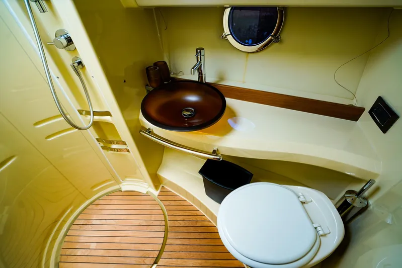 Queen Of Ark Yacht Photos Pics Luxurious bathroom in 2017 Azimut 42 Fly yacht with modern fixtures and wooden flooring.