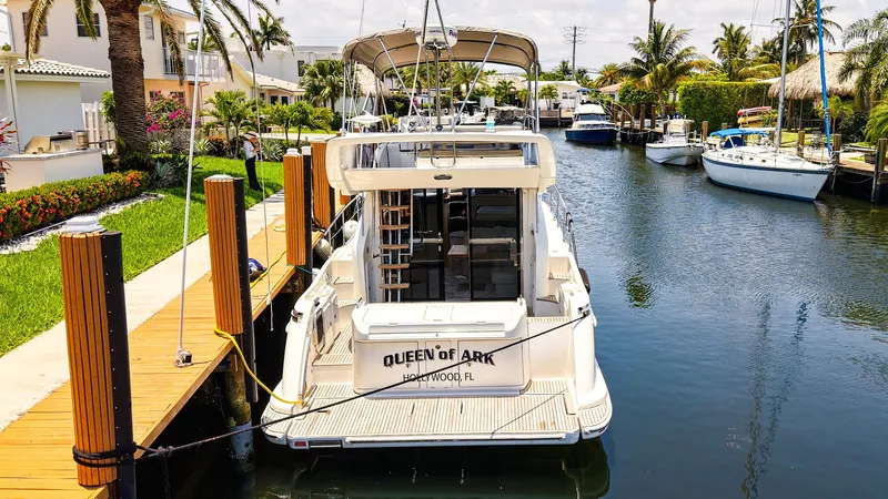 Queen Of Ark Yacht Photos Pics 2017 Azimut 42 Fly yacht docked in a scenic canal with lush surroundings.