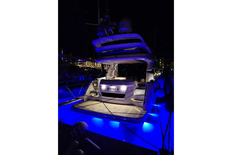  Yacht Photos Pics Luxurious 2019 Princess F55 yacht illuminated with blue lights at night.