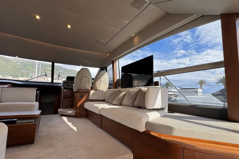  Yacht Photos Pics Luxurious interior of 2019 Princess F55 yacht with panoramic windows and plush seating.