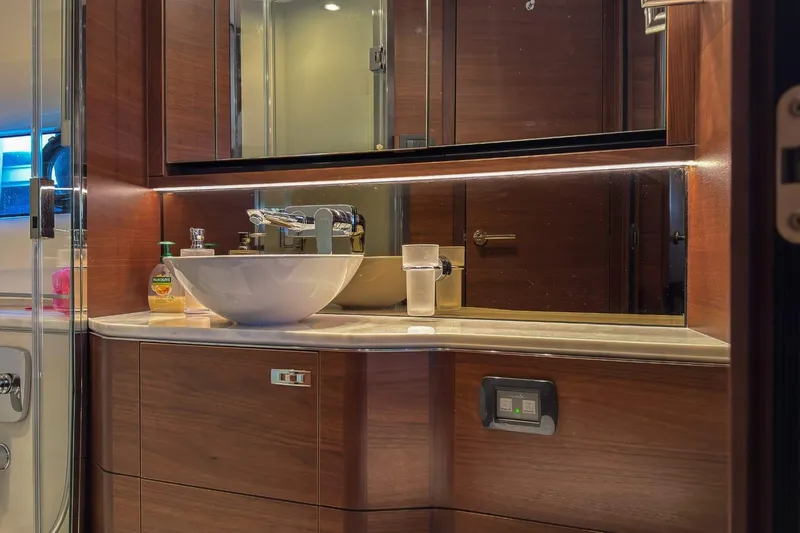  Yacht Photos Pics Luxurious bathroom in 2019 Princess F55 yacht with modern sink and wooden cabinetry.