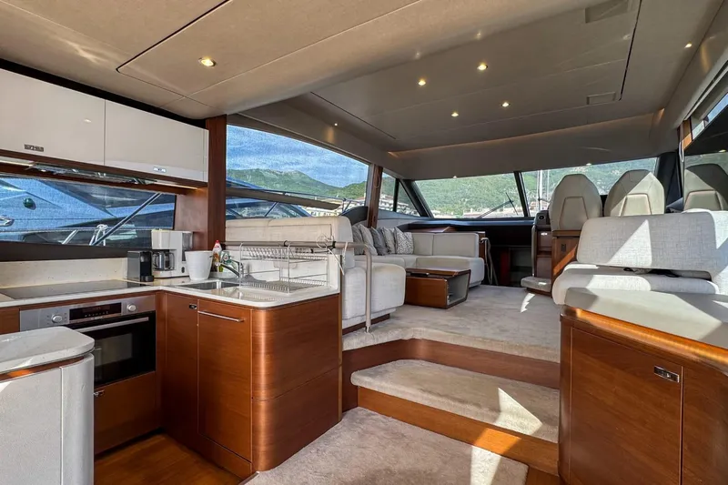  Yacht Photos Pics Luxurious interior of 2019 Princess F55 yacht with modern kitchen and seating area.