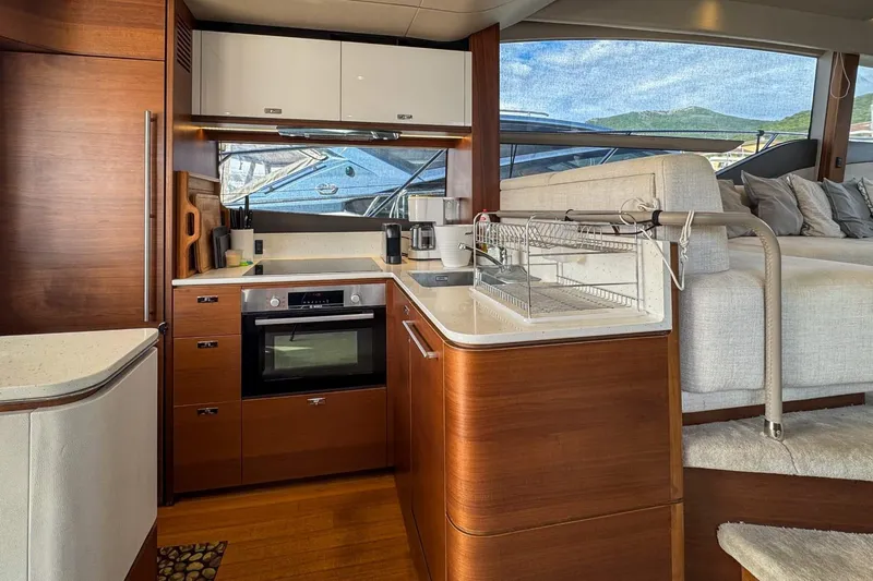  Yacht Photos Pics Luxurious 2019 Princess F55 yacht kitchen with modern appliances and elegant wood finish.