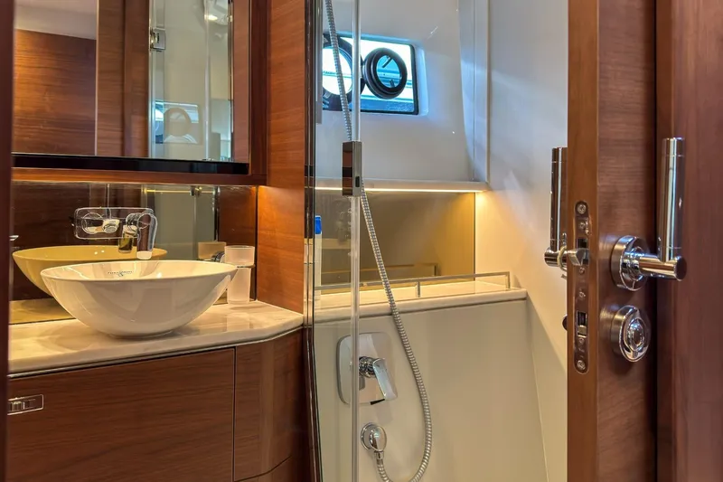  Yacht Photos Pics Luxurious bathroom in 2019 Princess F55 yacht with modern fixtures and elegant wood finishes.