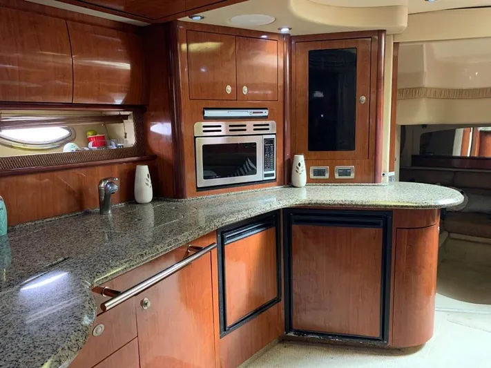 Gyspea 2005 Sea Ray 420 Da Yacht Photos Pics Luxurious kitchen interior of 2005 Sea Ray 420 Sundancer yacht with wood cabinetry and granite countertops.