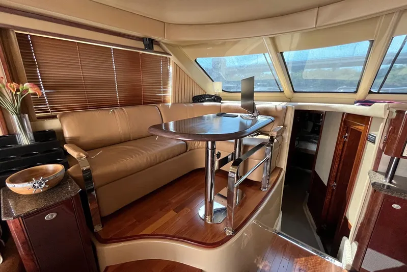 Acrux Yacht Photos Pics Luxurious interior of 2007 Sea Ray 52 Sedan Bridge yacht with leather seating and wooden accents.