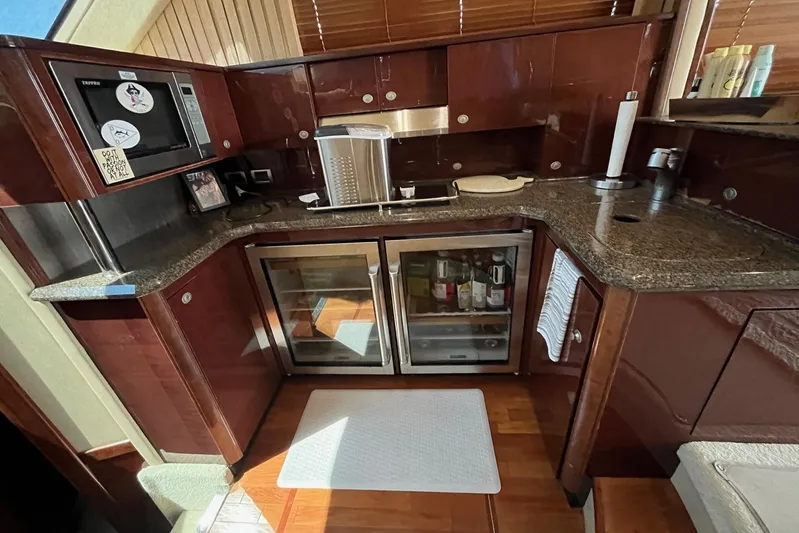 Acrux Yacht Photos Pics Luxurious kitchen area in a 2007 Sea Ray 52 Sedan Bridge yacht with modern amenities.