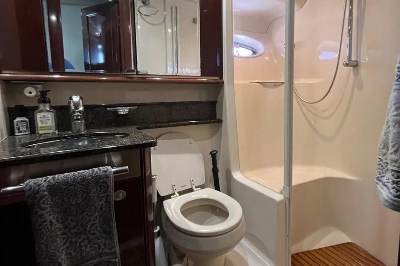 Acrux Yacht Photos Pics Luxurious bathroom in 2007 Sea Ray 52 Sedan Bridge yacht with shower and granite countertop.