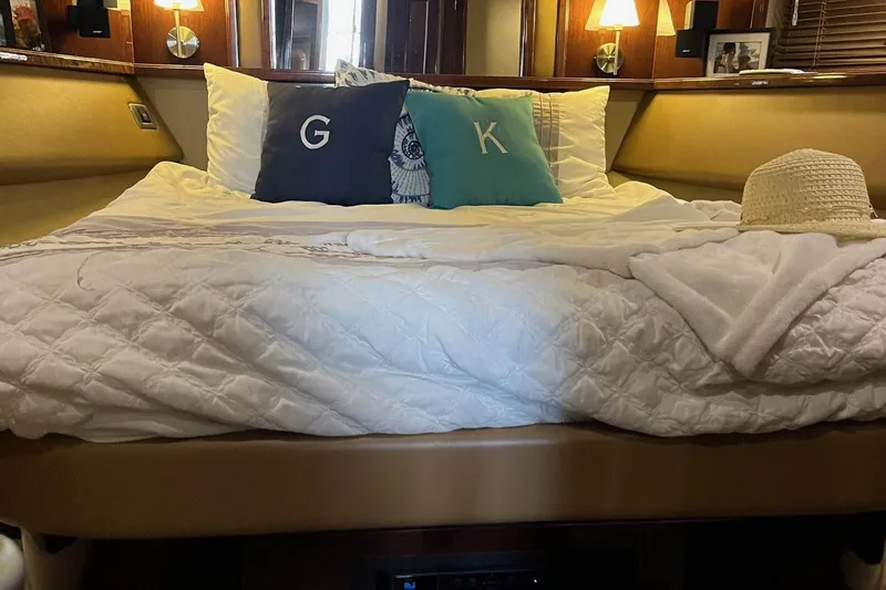 Acrux Yacht Photos Pics Luxurious bedroom interior of 2007 Sea Ray 52 Sedan Bridge yacht with cozy bedding.