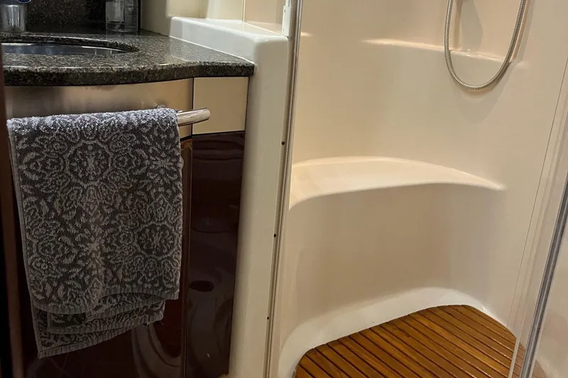 Acrux Yacht Photos Pics Luxurious bathroom interior of 2007 Sea Ray 52 Sedan Bridge yacht with shower and sink.