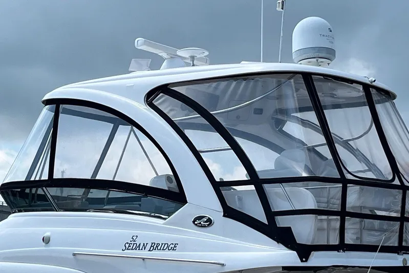 Acrux Yacht Photos Pics 2007 Sea Ray 52 Sedan Bridge yacht with enclosed flybridge against cloudy sky.
