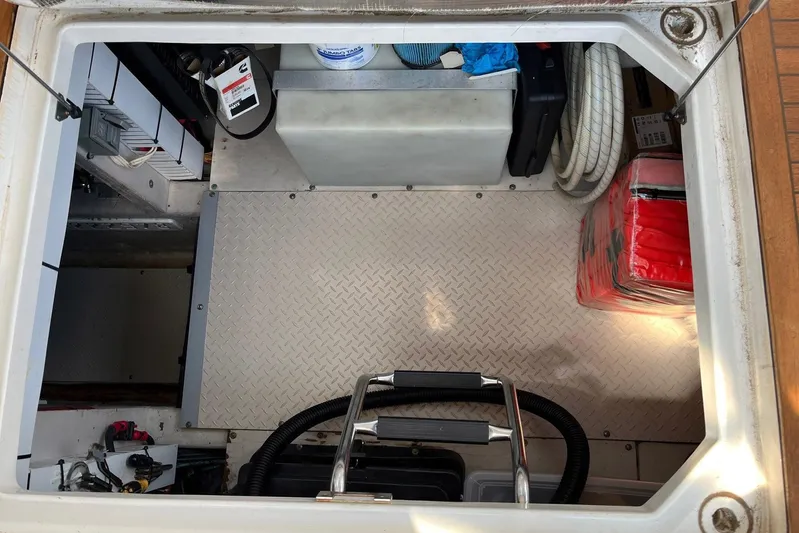 Acrux Yacht Photos Pics Engine compartment of 2007 Sea Ray 52 Sedan Bridge with equipment and storage items.