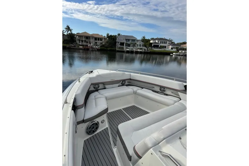  Yacht Photos Pics 2018 Formula 430 Super Sport Crossover boat interior with luxurious seating by a serene waterfront.