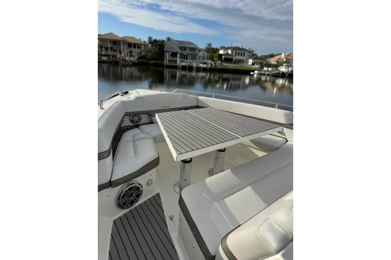  Yacht Photos Pics 2018 Formula 430 Super Sport Crossover boat with elegant seating and table on calm water.