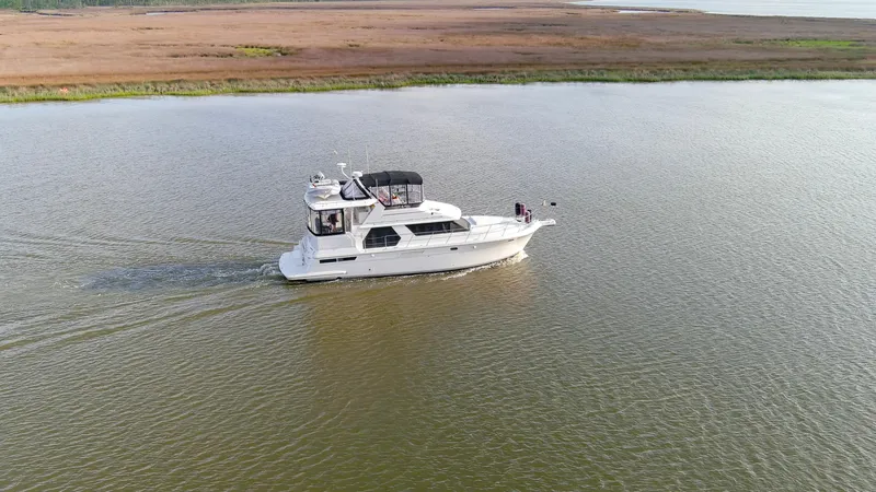 Zodiac Gypsea Yacht Photos Pics 1997 Carver 445 Aft Cabin Motor Yacht cruising on calm waters.