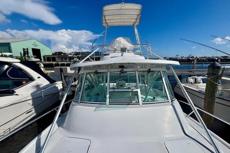  Yacht Photos Pics 2002 Luhrs 32 Open boat docked at marina under clear blue sky.