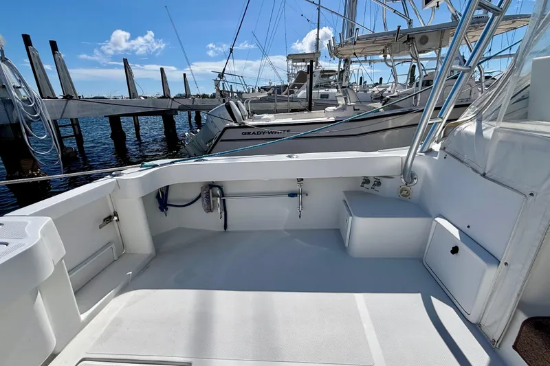  Yacht Photos Pics 2002 Luhrs 32 Open boat cockpit with marina view, featuring clean white deck and seating.