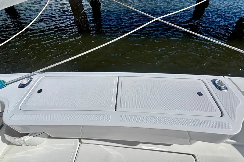  Yacht Photos Pics 2002 Luhrs 32 Open boat deck with storage compartments, docked by water.