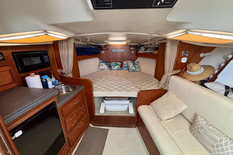  Yacht Photos Pics Interior of 2002 Luhrs 32 Open boat with cozy cabin and kitchenette.
